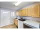 Well-equipped laundry room with ample cabinet space, a utility sink, and modern washer and dryer at 5990 Mcleod Dr, Las Vegas, NV 89120