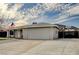 Ranch-style home with a spacious driveway, two-car garage, and desert landscape at 604 Canyon Rd, Henderson, NV 89002