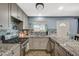 A modern kitchen featuring granite countertops, stainless steel appliances, and stylish backsplash at 604 Canyon Rd, Henderson, NV 89002