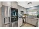 Spacious kitchen featuring stainless steel appliances, gray cabinets, and a granite countertop at 604 Canyon Rd, Henderson, NV 89002