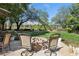 A stone firepit in the backyard offers ample seating and relaxing views at 613 Pinnacle Heights Ln, Las Vegas, NV 89144