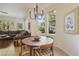 Bright breakfast nook features a round table, chandelier lighting, and views of the outdoor landscape at 613 Pinnacle Heights Ln, Las Vegas, NV 89144