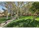 Tree lined community park featuring walking path and benches surrounded by lush green grass at 613 Pinnacle Heights Ln, Las Vegas, NV 89144