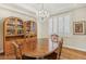 Elegant dining room features a wooden table with chairs, chandelier lighting, and a decorative china cabinet at 613 Pinnacle Heights Ln, Las Vegas, NV 89144