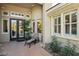 Covered entrance with double doors, modern lighting, and elegant desert landscaping at 613 Pinnacle Heights Ln, Las Vegas, NV 89144