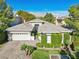 Inviting home featuring a paved driveway, lush lawn, and decorative shrubs enhancing curb appeal at 613 Pinnacle Heights Ln, Las Vegas, NV 89144