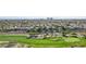 A lush green golf course with sand traps and manicured lawns surrounds upscale homes in a desert landscape at 613 Pinnacle Heights Ln, Las Vegas, NV 89144