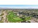 A lush green golf course with sand traps and luxury homes in the background under a clear blue sky and mountain views at 613 Pinnacle Heights Ln, Las Vegas, NV 89144