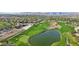 The golf course features rolling hills, a lake, sand traps, and manicured greens with homes in the distance at 613 Pinnacle Heights Ln, Las Vegas, NV 89144