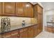 Kitchen showcasing granite countertops, wood cabinetry, and an additional storage area at 613 Pinnacle Heights Ln, Las Vegas, NV 89144