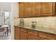 Kitchen counter with tile backsplash and wooden cabinets; view of breakfast nook at 613 Pinnacle Heights Ln, Las Vegas, NV 89144