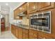 A well-appointed kitchen featuring wood cabinetry, stainless steel appliances and granite countertops at 613 Pinnacle Heights Ln, Las Vegas, NV 89144