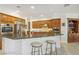 Bright and airy kitchen featuring a granite breakfast bar, stainless steel appliances, and ample cabinet space at 613 Pinnacle Heights Ln, Las Vegas, NV 89144