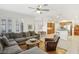 Open-concept living room with a ceiling fan, fireplace, and comfortable furniture at 613 Pinnacle Heights Ln, Las Vegas, NV 89144