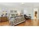 Well-lit main bedroom with hardwood floors, a decorative ceiling light, and shuttered windows at 613 Pinnacle Heights Ln, Las Vegas, NV 89144