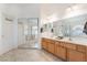 Bathroom featuring a double vanity sink, soaking tub, and mirrored closet at 6608 Ringbill Ct, North Las Vegas, NV 89084