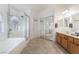 Bright bathroom featuring a soaking tub, glass shower, and double vanity sinks at 6608 Ringbill Ct, North Las Vegas, NV 89084