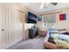 A cozy bedroom featuring carpet floors, a ceiling fan, and a double door closet at 6608 Ringbill Ct, North Las Vegas, NV 89084