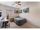 This bedroom offers a comfortable space with carpet floors and a ceiling fan at 6608 Ringbill Ct, North Las Vegas, NV 89084