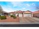 Charming single-story home featuring a well-maintained front yard, three-car garage, and tiled roof at 6608 Ringbill Ct, North Las Vegas, NV 89084