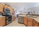 Kitchen featuring stainless steel appliances, wood cabinetry, and tile flooring at 6608 Ringbill Ct, North Las Vegas, NV 89084