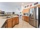 Kitchen featuring stainless steel appliances, tile flooring, and wood cabinetry at 6608 Ringbill Ct, North Las Vegas, NV 89084