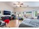 Bright main bedroom with hardwood floors, large windows, and a ceiling fan at 6608 Ringbill Ct, North Las Vegas, NV 89084