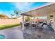 Covered patio with outdoor seating, dining area, and views of the landscaped backyard at 6608 Ringbill Ct, North Las Vegas, NV 89084