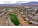 Scenic aerial view showcases the golf course community, highlighting home location and mountain views at 704 Peachy Canyon Cir # 101, Las Vegas, NV 89144