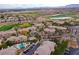 Overhead view showcasing community pool, landscaping, and surrounding golf course at 704 Peachy Canyon Cir # 101, Las Vegas, NV 89144