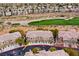 Aerial view showcasing community, golf course and this townhome complex, highlighting the unit location at 704 Peachy Canyon Cir # 101, Las Vegas, NV 89144