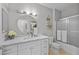 Bright bathroom featuring a modern vanity with marble countertop and a shower with sliding glass doors at 704 Peachy Canyon Cir # 101, Las Vegas, NV 89144