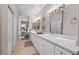 Elegant bathroom featuring double sinks, quartz countertops, stylish mirrors and modern lighting at 704 Peachy Canyon Cir # 101, Las Vegas, NV 89144