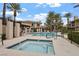 Inviting community pool and spa area with comfortable lounge seating and palm trees at 704 Peachy Canyon Cir # 101, Las Vegas, NV 89144