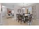 Inviting dining area with a wooden table set for six, complemented by modern window treatments at 704 Peachy Canyon Cir # 101, Las Vegas, NV 89144