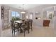 Inviting dining area with a wooden table set for six, complemented by modern window treatments at 704 Peachy Canyon Cir # 101, Las Vegas, NV 89144