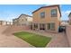 Backyard with artificial grass, stone, and block wall at 7462 Dragonfruit Ave, Las Vegas, NV 89113