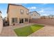 A backyard featuring artificial grass, stone, and desert landscaping at 7462 Dragonfruit Ave, Las Vegas, NV 89113