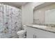 Bathroom featuring a shower and a granite vanity with white cabinetry and chrome hardware at 7462 Dragonfruit Ave, Las Vegas, NV 89113