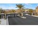 View of the community entrance gate with desert landscaping and well-maintained homes at 7462 Dragonfruit Ave, Las Vegas, NV 89113