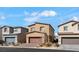 View of a home with neutral-colored exterior, two-car garage, and desert landscaping at 7462 Dragonfruit Ave, Las Vegas, NV 89113