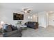 Comfortable living room features neutral paint, a ceiling fan, and tile flooring, perfect for relaxation at 7462 Dragonfruit Ave, Las Vegas, NV 89113