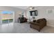 Cozy living room with tile flooring, large TV, and access to the backyard patio through sliding glass doors at 7462 Dragonfruit Ave, Las Vegas, NV 89113