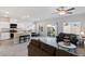 Open-concept living room with stainless steel appliances, tile floors, and sliding glass doors at 7462 Dragonfruit Ave, Las Vegas, NV 89113