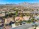 Expansive aerial view of the community showing single-story homes, desert landscaping and stunning mountain views at 77 Chapman Heights St, Las Vegas, NV 89138