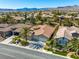 Gorgeous aerial view of a home with a lush backyard pool, desert landscaping, and a well-maintained community at 77 Chapman Heights St, Las Vegas, NV 89138