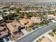 Beautiful aerial view of a single-story home featuring a red-tiled roof, desert landscaping and a backyard pool at 77 Chapman Heights St, Las Vegas, NV 89138