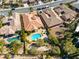 Aerial view featuring homes with pools, mature trees, and manicured landscaping at 77 Chapman Heights St, Las Vegas, NV 89138