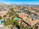 Wide aerial view of a residential area with neatly arranged houses and mature trees at 77 Chapman Heights St, Las Vegas, NV 89138