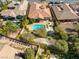 Aerial view of a backyard featuring a private pool, mature trees, and manicured landscaping at 77 Chapman Heights St, Las Vegas, NV 89138